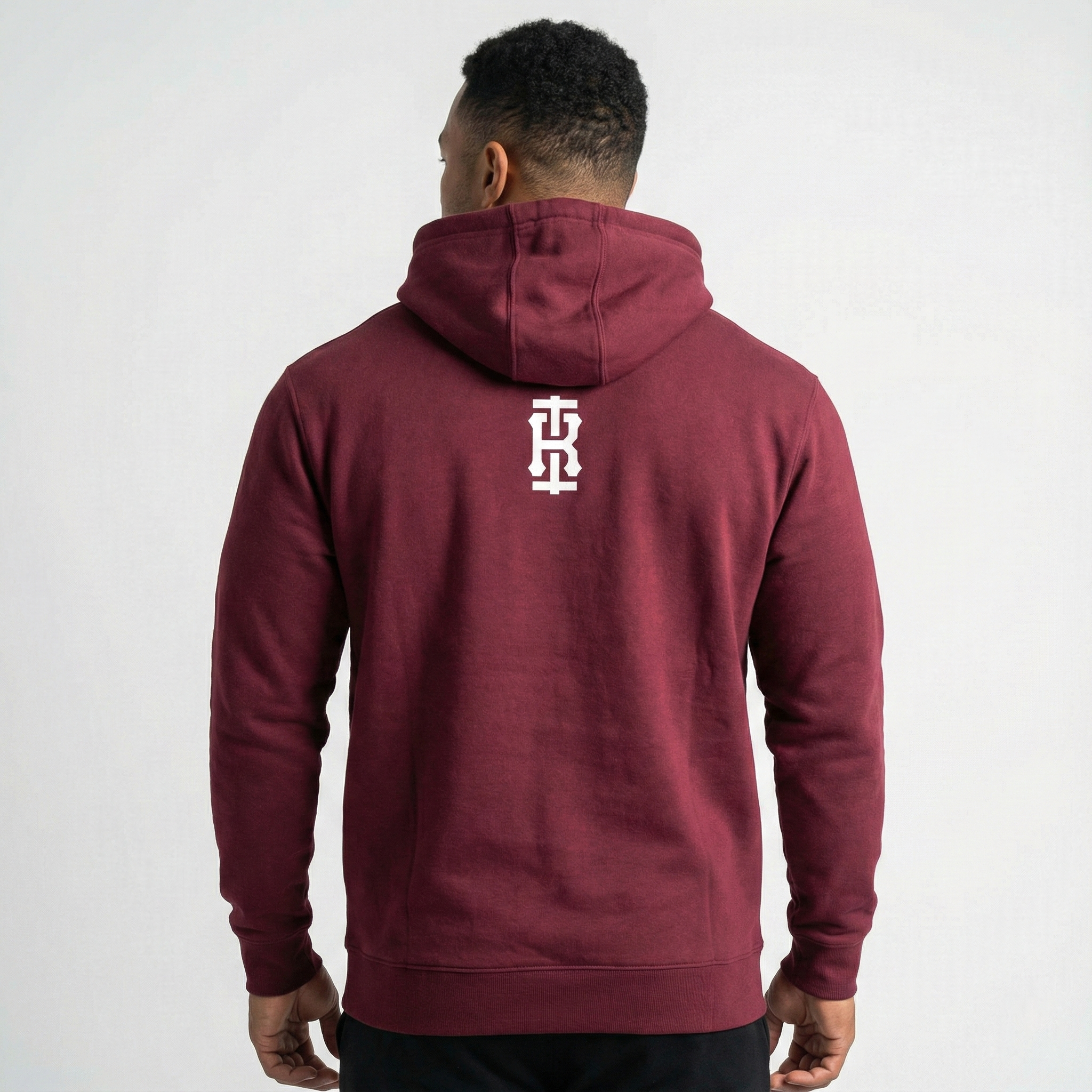 Back view of Iron Rebel maroon pullover hoodie for men featuring minimalist Iron Rebel logo, premium strength training sweatshirt